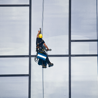 worker-hanging-off-buidling